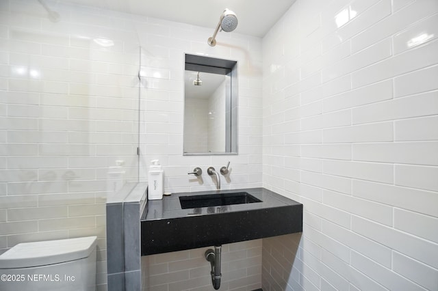 1927 Beachside Ct, Atlantic Beach, FL 32233 - bathroom with tile walls, a sink, toilet, and tasteful backsplash