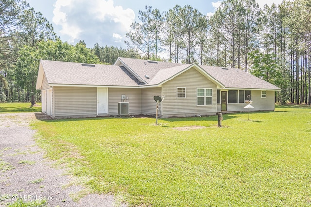 6645 Elvin Starling Rd, Macclenny, FL 32063 - back of property featuring a yard, a shingled roof, gravel driveway, and central air condition unit