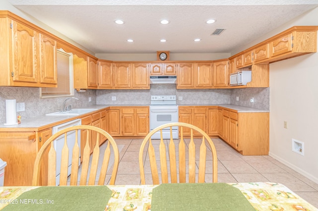 6645 Elvin Starling Rd, Macclenny, FL 32063 - kitchen featuring white appliances, a sink, under cabinet range hood, recessed lighting, and light countertops