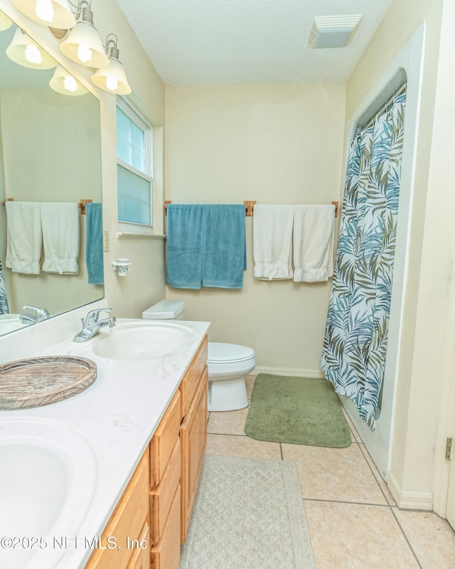 6645 Elvin Starling Rd, Macclenny, FL 32063 - full bath featuring toilet, baseboards, double vanity, tile patterned floors, and curtained shower