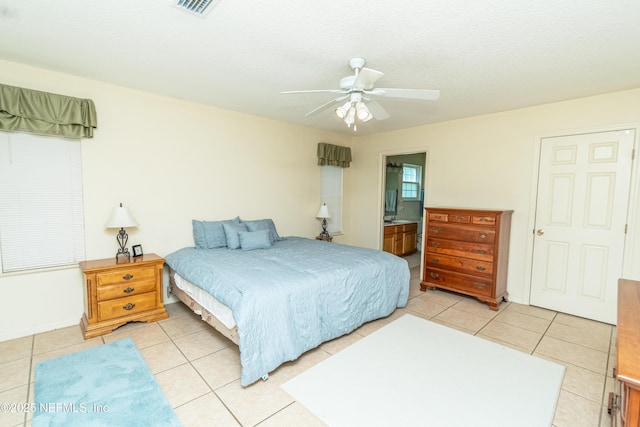 6645 Elvin Starling Rd, Macclenny, FL 32063 - bedroom featuring light tile patterned floors, ceiling fan, and ensuite bath