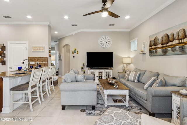 2695 Morning Light Ct, Flagler Beach, FL 32136 - living room featuring a ceiling fan, ornamental molding, arched walkways, light tile patterned flooring, and recessed lighting