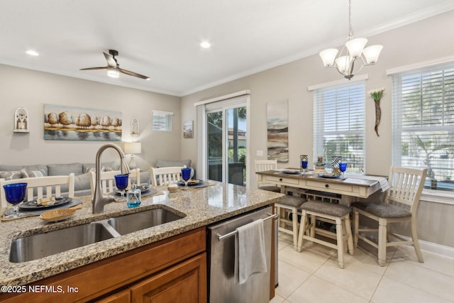 2695 Morning Light Ct, Flagler Beach, FL 32136 - kitchen featuring dishwasher, a sink, brown cabinets, light tile patterned floors, and crown molding