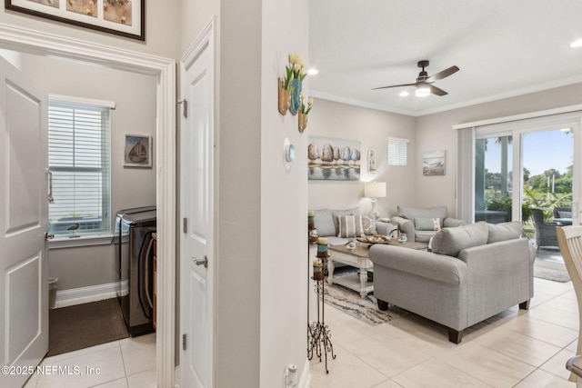 2695 Morning Light Ct, Flagler Beach, FL 32136 - living room featuring light tile patterned flooring, ceiling fan, plenty of natural light, ornamental molding, and washer / clothes dryer