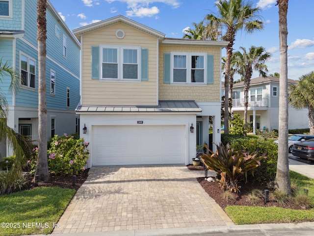 2695 Morning Light Ct, Flagler Beach, FL 32136 - view of front of home with a standing seam roof, an attached garage, decorative driveway, and metal roof