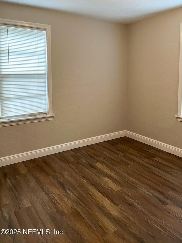 4522 Kingsbury St, Jacksonville, FL 32205 - empty room with dark wood-type flooring and baseboards