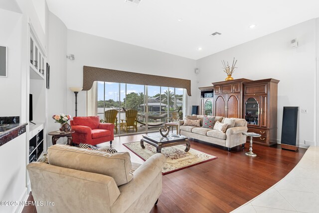 12 Collingville Ct, Palm Coast, FL 32137 - living room featuring a towering ceiling, wood finished floors, and recessed lighting