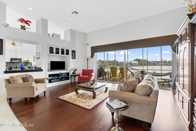 12 Collingville Ct, Palm Coast, FL 32137 - living room featuring wood finished floors, a high ceiling, and recessed lighting