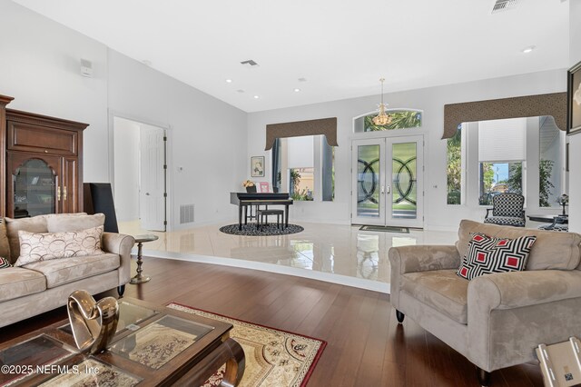 12 Collingville Ct, Palm Coast, FL 32137 - living area featuring hardwood / wood-style flooring, recessed lighting, french doors, and a towering ceiling