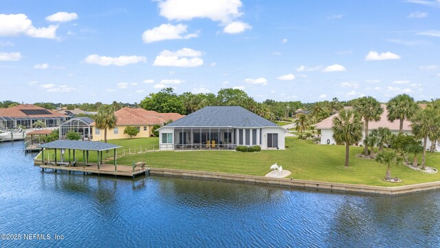 12 Collingville Ct, Palm Coast, FL 32137 - dock area with a water view, a lawn, a residential view, and boat lift