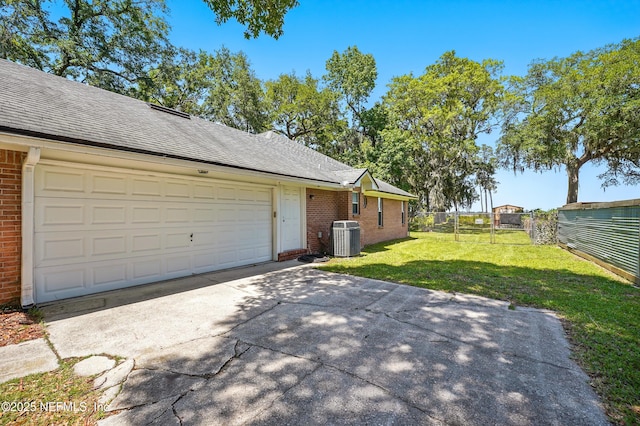 1205 Eagle Bend Ct, Jacksonville, FL 32226 - view of side of property with brick siding, central AC, driveway, and roof with shingles