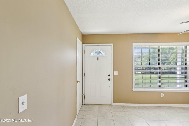 10 Sesame St, Middleburg, FL 32068 - foyer featuring baseboards, light tile patterned floors, and a textured ceiling