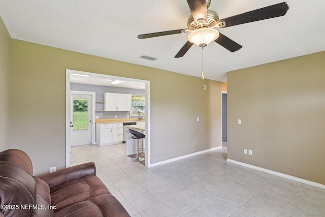 10 Sesame St, Middleburg, FL 32068 - living room featuring ceiling fan, light tile patterned floors, and baseboards