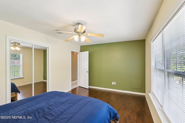 10 Sesame St, Middleburg, FL 32068 - bedroom with wood finished floors, baseboards, ceiling fan, a closet, and a textured ceiling