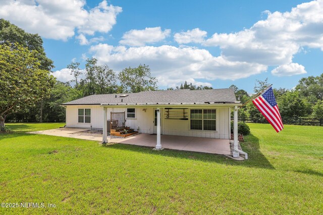 10 Sesame St, Middleburg, FL 32068 - back of house with a patio area, a lawn, and board and batten siding