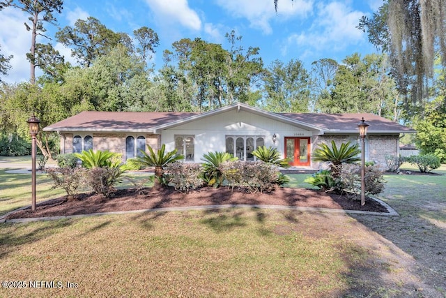 10859 Windy Gale Dr W, Jacksonville, FL 32218 - single story home featuring a front lawn, french doors, and brick siding
