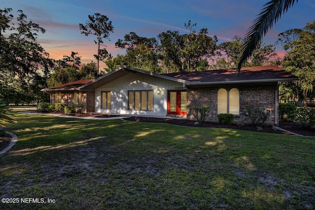 10859 Windy Gale Dr W, Jacksonville, FL 32218 - view of front of home featuring a front yard, brick siding, and french doors