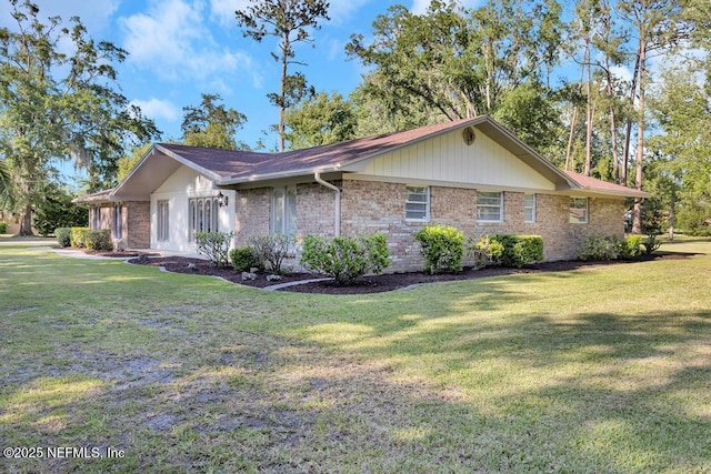 10859 Windy Gale Dr W, Jacksonville, FL 32218 - view of home's exterior featuring a lawn and brick siding