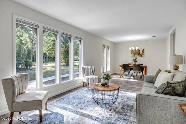 10859 Windy Gale Dr W, Jacksonville, FL 32218 - living area featuring a chandelier, wood finished floors, and baseboards