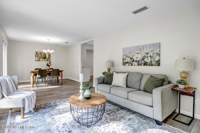 10859 Windy Gale Dr W, Jacksonville, FL 32218 - living room featuring wood finished floors, a chandelier, and baseboards