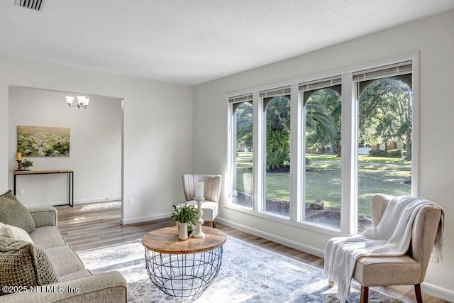 10859 Windy Gale Dr W, Jacksonville, FL 32218 - living room with plenty of natural light, a chandelier, wood finished floors, and baseboards