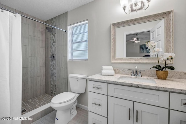 10859 Windy Gale Dr W, Jacksonville, FL 32218 - bathroom with toilet, a tile shower, vanity, wood finished floors, and baseboards