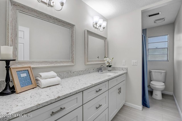 10859 Windy Gale Dr W, Jacksonville, FL 32218 - bathroom featuring baseboards, vanity, toilet, and a textured ceiling