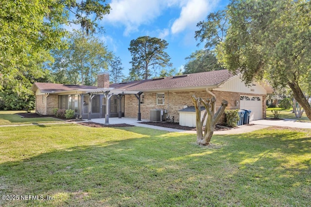 10859 Windy Gale Dr W, Jacksonville, FL 32218 - view of front of home with brick siding, a sunroom, a garage, a chimney, and a front lawn