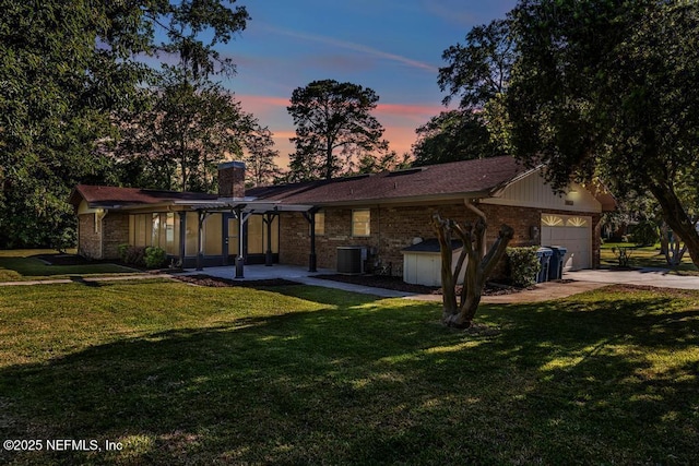 10859 Windy Gale Dr W, Jacksonville, FL 32218 - view of front facade featuring a front lawn, a chimney, an attached garage, and brick siding