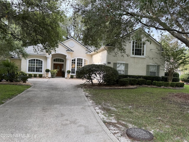 526 Oakmont Dr, Orange Park, FL 32073 - view of front of home with concrete driveway, stucco siding, and a front lawn