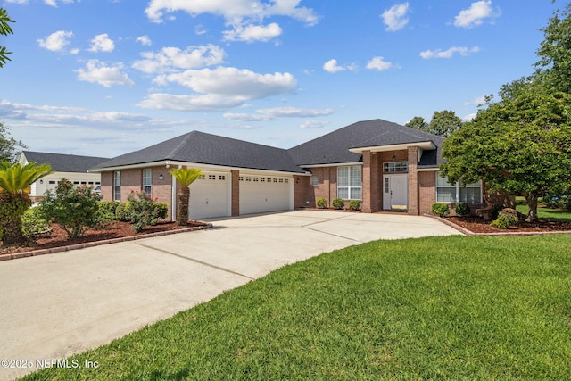 3384 Olympic Dr, Green Cove Springs, FL 32043 - view of front facade with brick siding, an attached garage, concrete driveway, and a front lawn