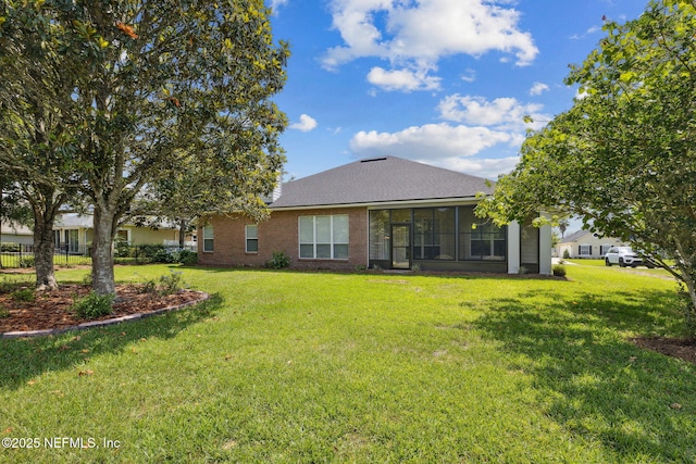 3384 Olympic Dr, Green Cove Springs, FL 32043 - back of house with a yard, roof with shingles, and a sunroom