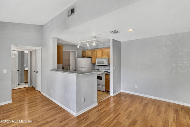 7701 Timberlin Park Blvd Unit 1535, Jacksonville, FL 32256 - kitchen with white appliances, light wood-style flooring, a peninsula, and baseboards