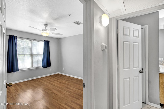 7701 Timberlin Park Blvd Unit 1535, Jacksonville, FL 32256 - unfurnished room featuring ceiling fan, baseboards, wood finished floors, a pendent fire sprinkler, and a textured ceiling
