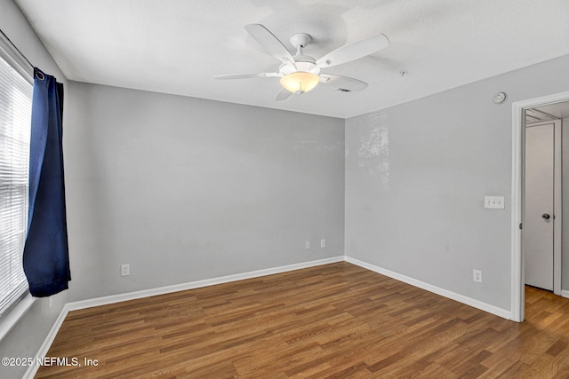 7701 Timberlin Park Blvd Unit 1535, Jacksonville, FL 32256 - empty room featuring wood finished floors, healthy amount of natural light, a ceiling fan, and baseboards