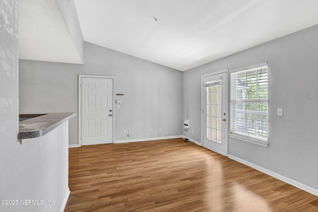 7701 Timberlin Park Blvd Unit 1535, Jacksonville, FL 32256 - unfurnished room featuring wood finished floors, baseboards, and vaulted ceiling