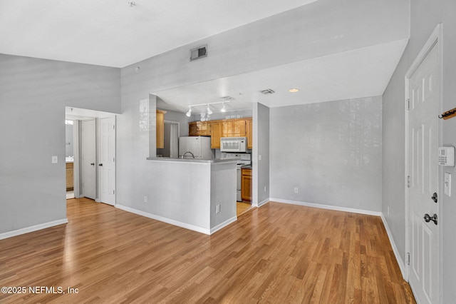 7701 Timberlin Park Blvd Unit 1535, Jacksonville, FL 32256 - unfurnished living room featuring light wood-style flooring, baseboards, and rail lighting