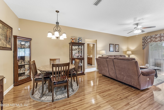 2615 Golden Lake Loop, Saint Augustine, FL 32084 - dining space featuring light wood-type flooring, a chandelier, and a ceiling fan