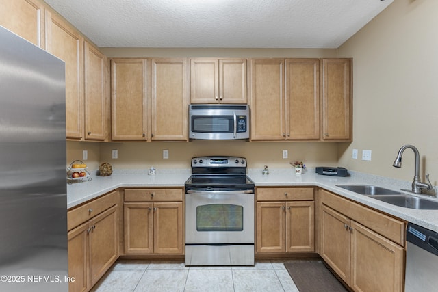 2615 Golden Lake Loop, Saint Augustine, FL 32084 - kitchen featuring appliances with stainless steel finishes, a sink, light countertops, light tile patterned floors, and a textured ceiling