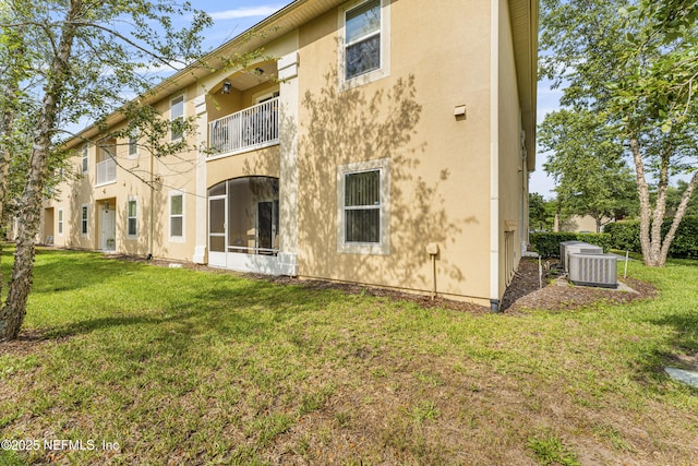 2615 Golden Lake Loop, Saint Augustine, FL 32084 - rear view of house with stucco siding, a yard, and cooling unit