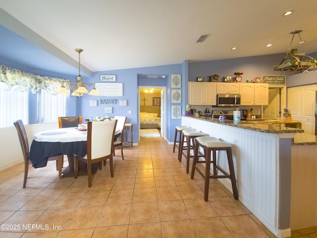 10031 SW 62nd Cir, Ocala, FL 34476 - dining space with light tile patterned floors, a chandelier, lofted ceiling, and recessed lighting