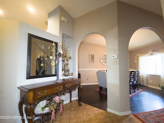 10031 SW 62nd Cir, Ocala, FL 34476 - hall featuring arched walkways, tile patterned floors, and baseboards