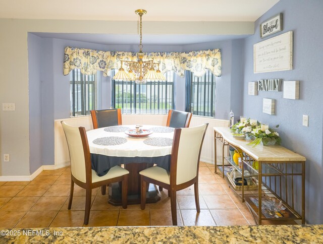 10031 SW 62nd Cir, Ocala, FL 34476 - dining area featuring a chandelier, tile patterned flooring, and baseboards
