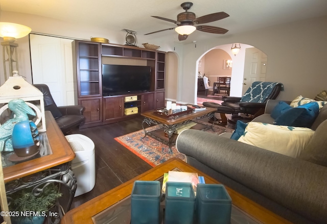 10031 SW 62nd Cir, Ocala, FL 34476 - living room featuring arched walkways, a ceiling fan, and dark wood finished floors