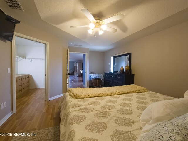 10031 SW 62nd Cir, Ocala, FL 34476 - bedroom featuring wood finished floors, ceiling fan, baseboards, and a spacious closet
