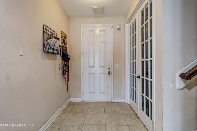 1071 Wetland Ridge Cir, Middleburg, FL 32068 - doorway with light tile patterned flooring and baseboards