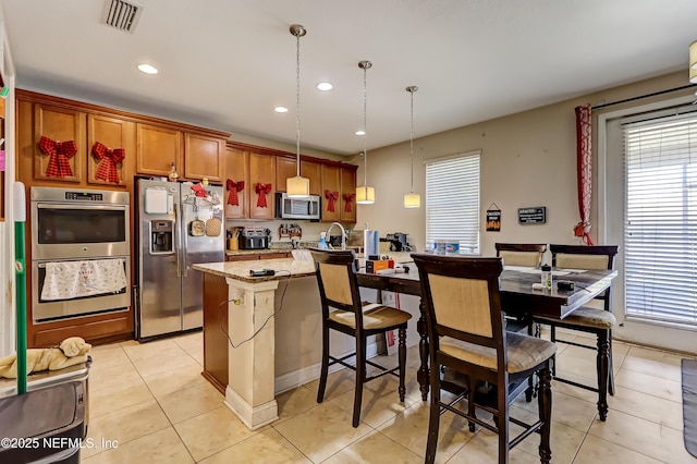 1071 Wetland Ridge Cir, Middleburg, FL 32068 - kitchen with stainless steel appliances, plenty of natural light, light tile patterned flooring, and recessed lighting