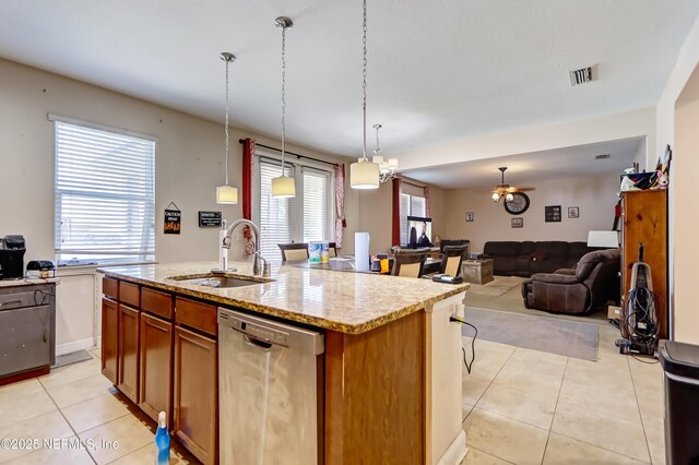 1071 Wetland Ridge Cir, Middleburg, FL 32068 - kitchen featuring stainless steel dishwasher, a sink, light tile patterned floors, open floor plan, and an island with sink
