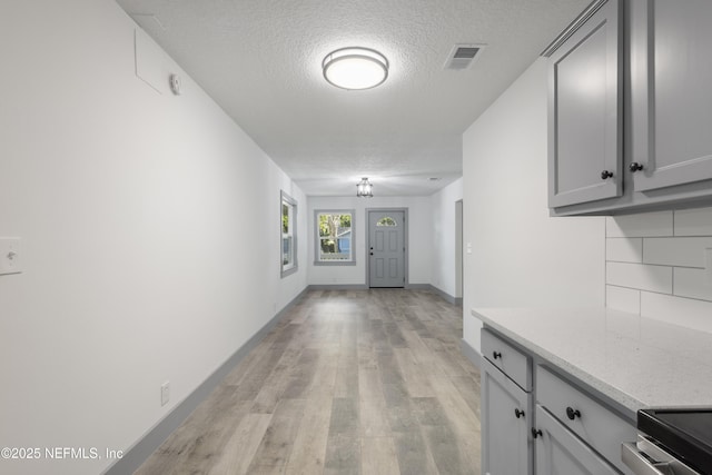 2210 Lamee Ave, Jacksonville, FL 32207 - hall with a textured ceiling, light wood-style flooring, and baseboards