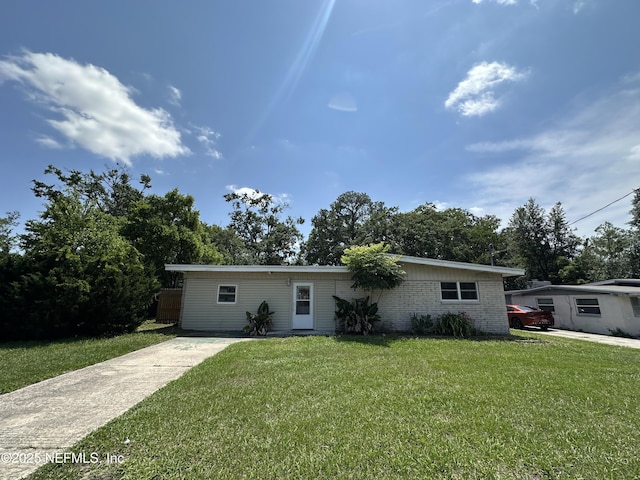 1927 Fouraker Rd, Jacksonville, FL 32210 - view of front of house with a front yard and brick siding